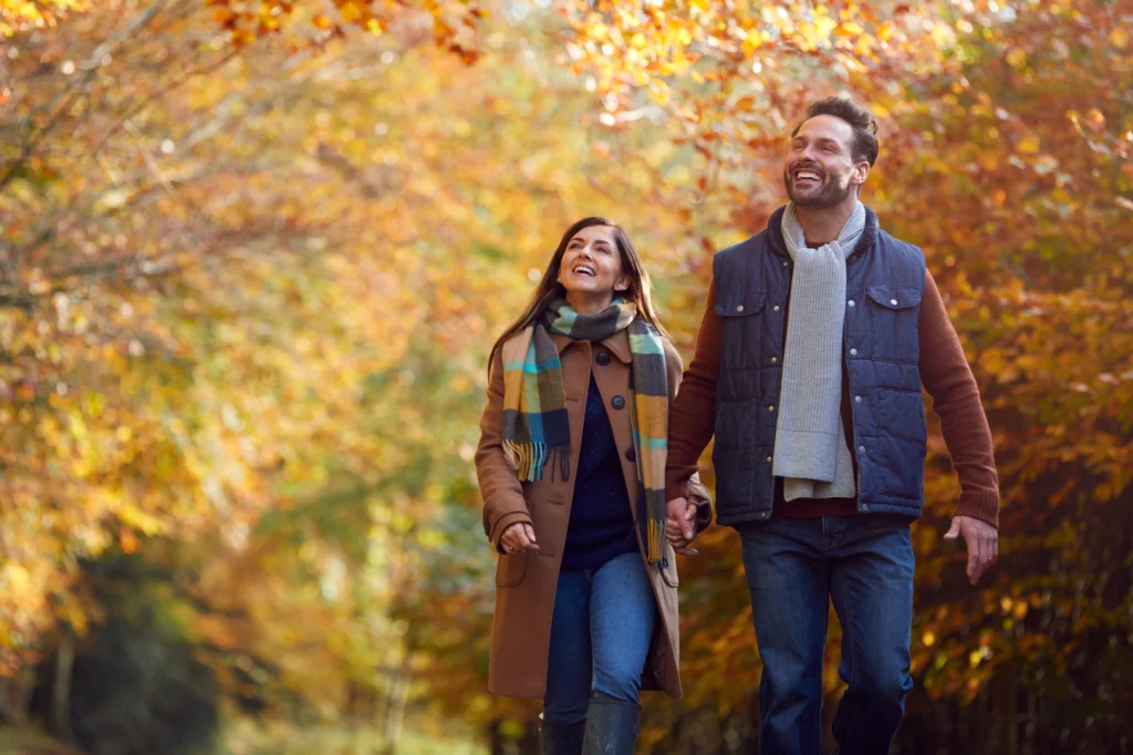 a couple walking in the nature that surrounds Wild Air Landing apartments in zionsville